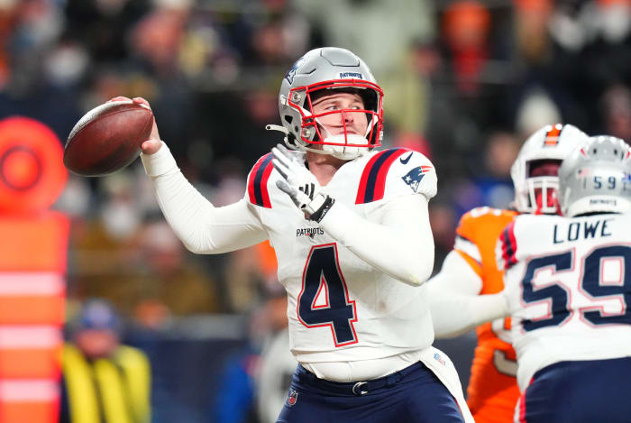 New England Patriots quarterback Bailey Zappe (4) prepares to pass in the first quarter against the Denver Broncos at Empower Field at Mile High.